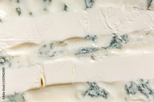 A mixture of gorgonzola cheeses with mascarpone macro. Light background eating dairy product.