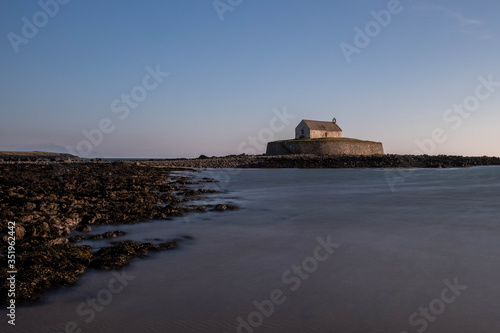 Church In The Sea, Porth Cwyfan, Anglesey in the dramatic landscapes of scenic Wales, fantastic adventure travel destination or holiday vacation to view picturesque scenery at sunrise or sunset