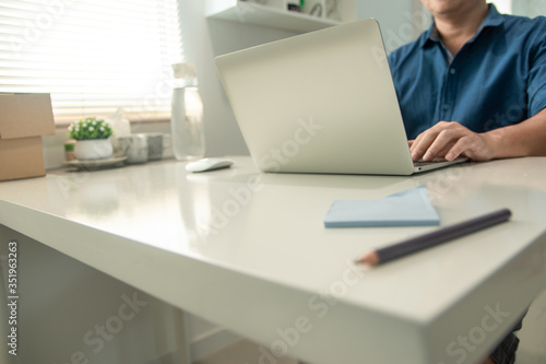 Men are using laptops on their dining tables at home. Working at home during the epidemic virus.