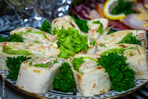 Pita bread with cheese and seafood on a plate decorated with parsley