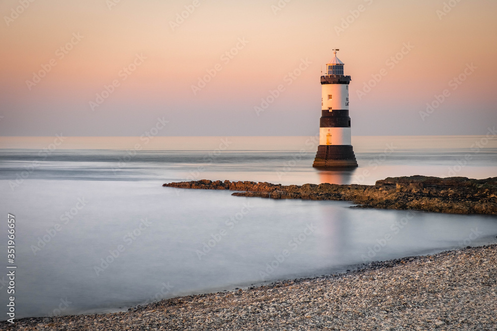 Penmon Point Lighthouse, Beaumaris Anglesey in the dramatic landscapes of scenic Wales, fantastic adventure travel destination or holiday vacation to view picturesque scenery at sunrise or sunset