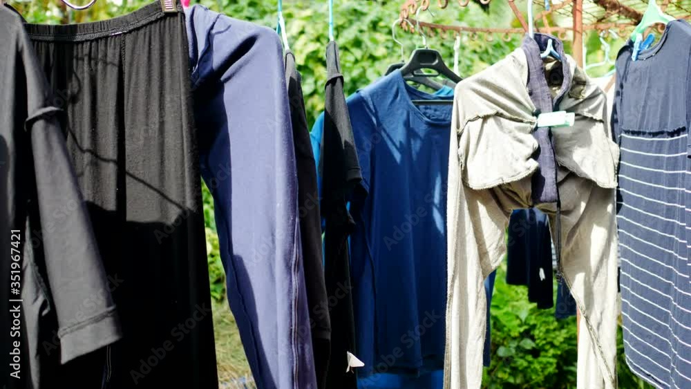 wet clean cloths hang on line to dry with soft wind and sunshine after