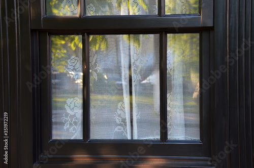 Vintage window with white tulle curtains