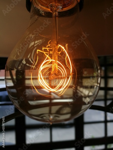 Close up of light bulb with intense light wires © rod