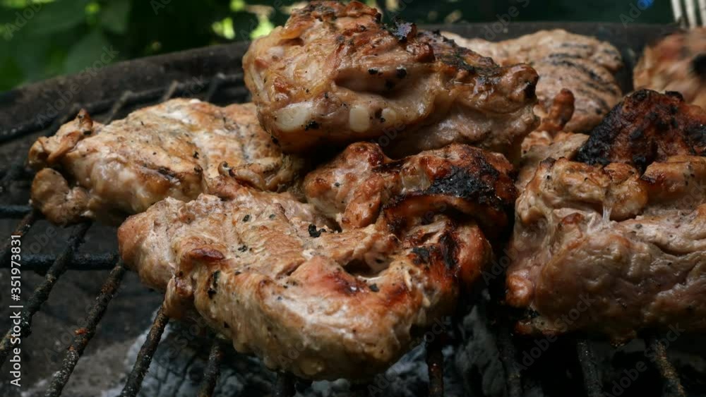 Grilling Meat. Barbecue grilling juicy appetizing pork steaks on grate. Cooking food on weekend. Close-up. Outdoors. Grilling Meat. Barbecue grilling juicy appetizing pork steaks on grate. Cooking food on weekend. Close-up. Outdoors.