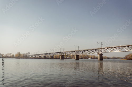 walk to the Dnieper. view of the Petrovsky railway bridge from the Gorbachykha tract. Warm October, autumn © yemets