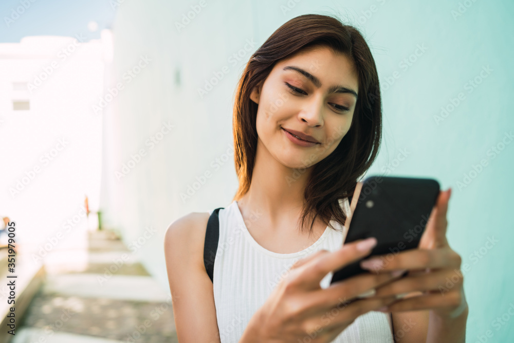 Young woman using her mobile phone. Young woman using her mobile phone.