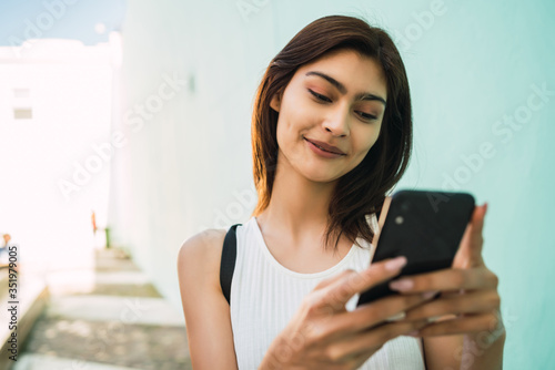 Young woman using her mobile phone.