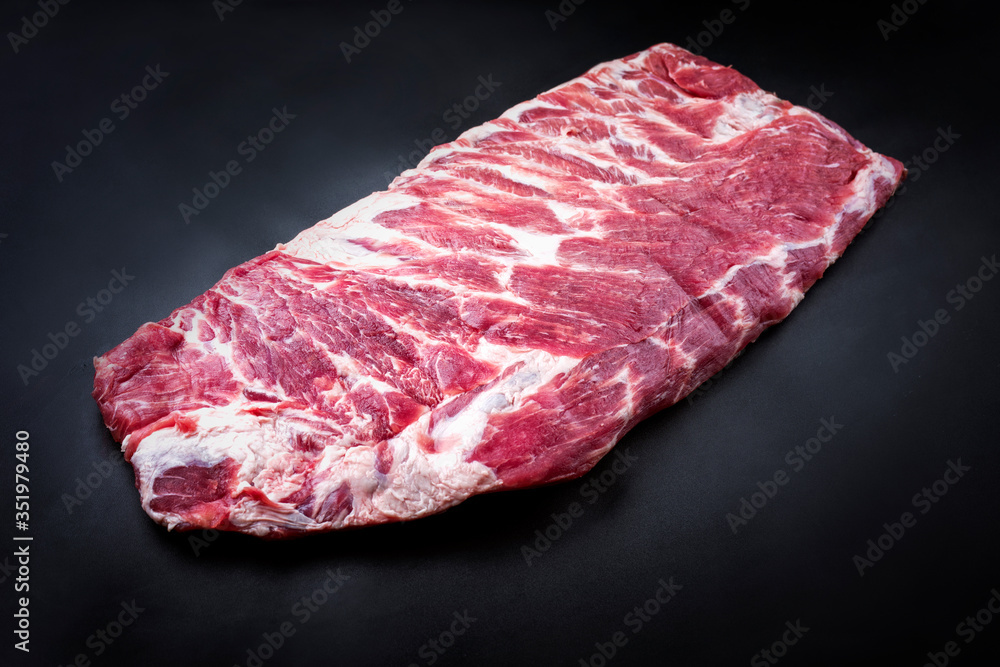 Obraz premium Raw veal spare loin ribs St Louis cut offered as top view on black background