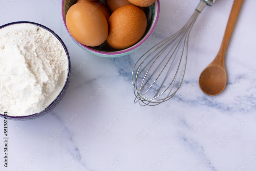Kitchen utensils for cooking, eggs and flour in bowl Kitchen utensils for cooking, eggs and flour in bowl