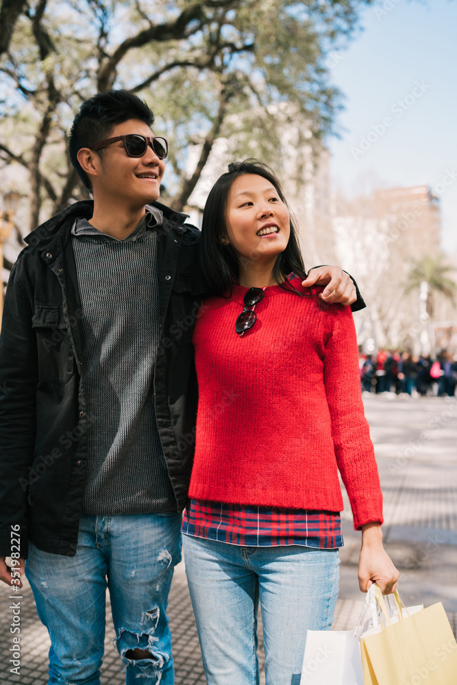 Asian couple walking in the city.