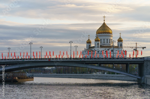 Moscow cityscape in the spring day. Cathedral of Christ the Saviour. Coronavirus pandemic time. Nobody. Bolshoy Kamenny Bridge is decorated by red flags by the Victory Day celebration on May 9
