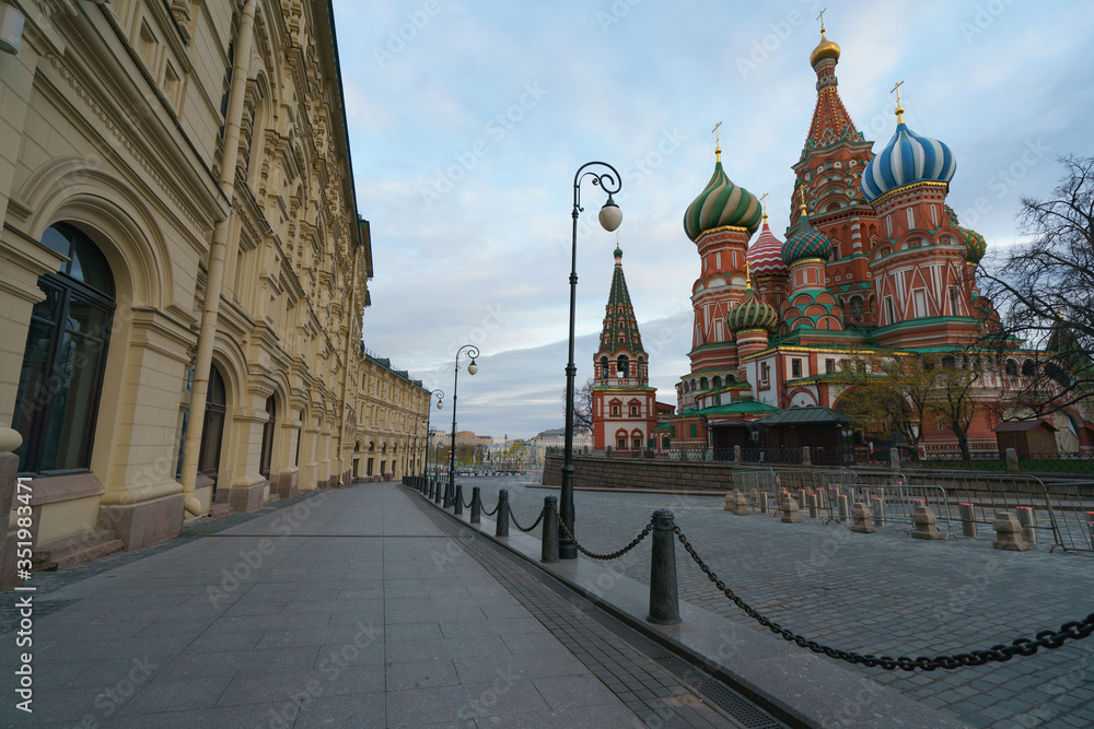 Obraz premium Photography of the domes of the Saint Basil's Cathedral / Cathedral of Vasily the Blessed and facades of GUM (Central Department Store). Moscow Red Square.Coronavirus pandemic time. No people.