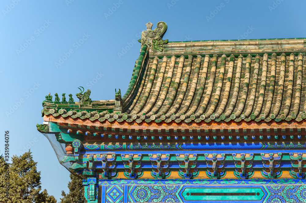 Richly decorated roofs of a Chinese temple, small colorful details with figurines.