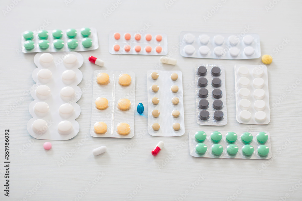 pills on white wooden table pills on white wooden table