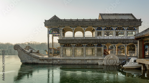 View from the pier in the summer palace on the marble boat of Empress Cixi moored on the lake.