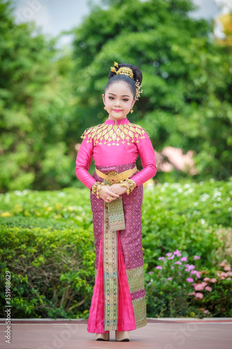 Portrait smiling Asia Girl in Thai Traditional Antique Dress of Old Kingdom in Siam, Southeast Asia.