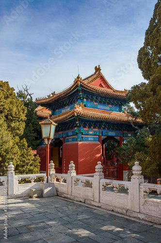 Traditional Chinese buildings on the temple grounds, numerous colorful paintings on the structure.