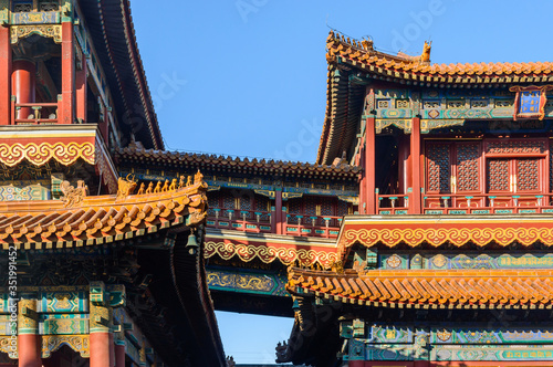 Richly decorated roofs of Chinese houses  small colorful details with figurines.