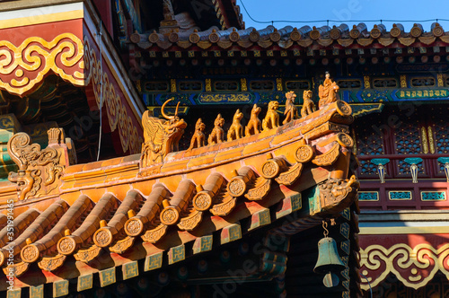 Richly decorated roofs of Chinese houses, small colorful details with figurines.