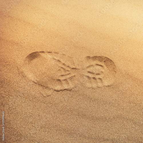 footprint with tread shoes on a sandy surface