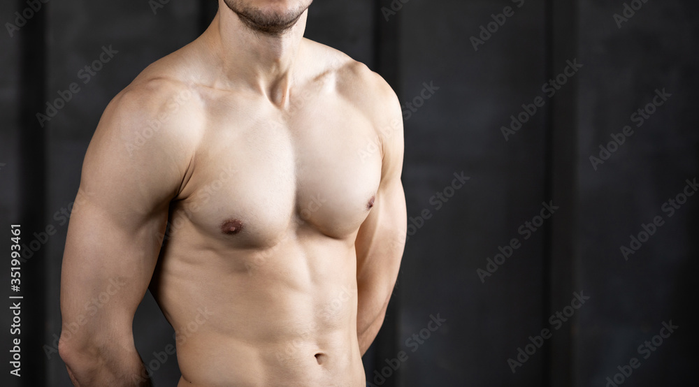 Muscle sexy young man shirtless. Strong bodybuilder close up.