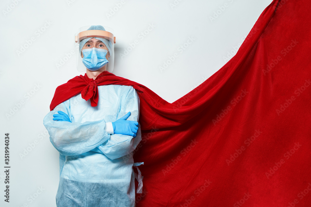 Doctor wearing surgical face mask in superhero cape.