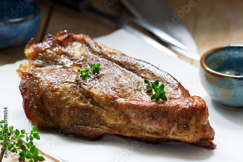 Baked pork shoulder on the bone with spices, herbs and aromatic oil.