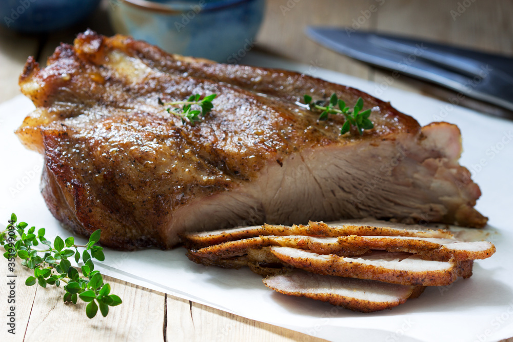 Baked pork shoulder on the bone with spices, herbs and aromatic oil.