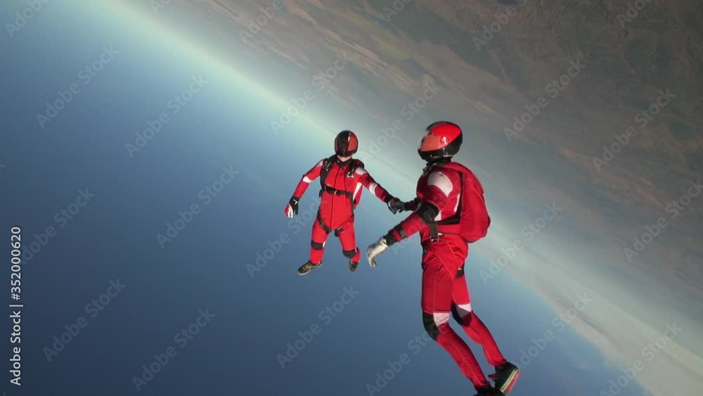 Skidiver rotates in free fall. Extreme sport concept. Skidiver rotates in free fall. Extreme sport concept.