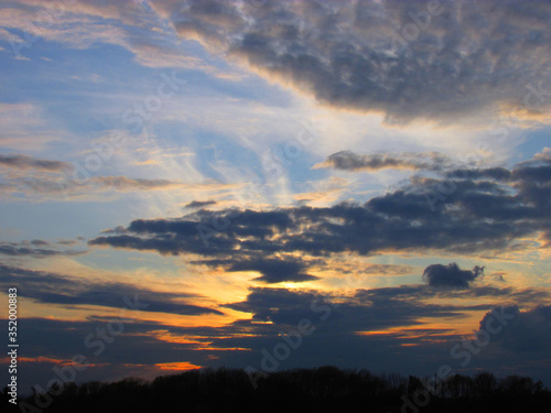 Background with dramatic sky with clouds at sunset