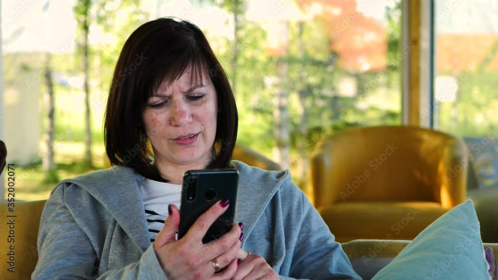 The woman was relaxing on the outdoor terrace and talking on a video call on her smartphone The woman was relaxing on the outdoor terrace and talking on a video call on her smartphone