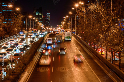 Beijing at night, driving cars on a busy road in the city. © Castigatio