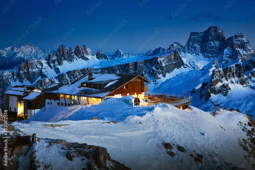 Rifugio Lagazuoi and Cable car station against the background of the Dolomites at sunset. Winter Alps near Cortina d'Ampezzo, Veneto, Italy. Postcard, Falzarego Pass, Dolomiti. Famous observation deck