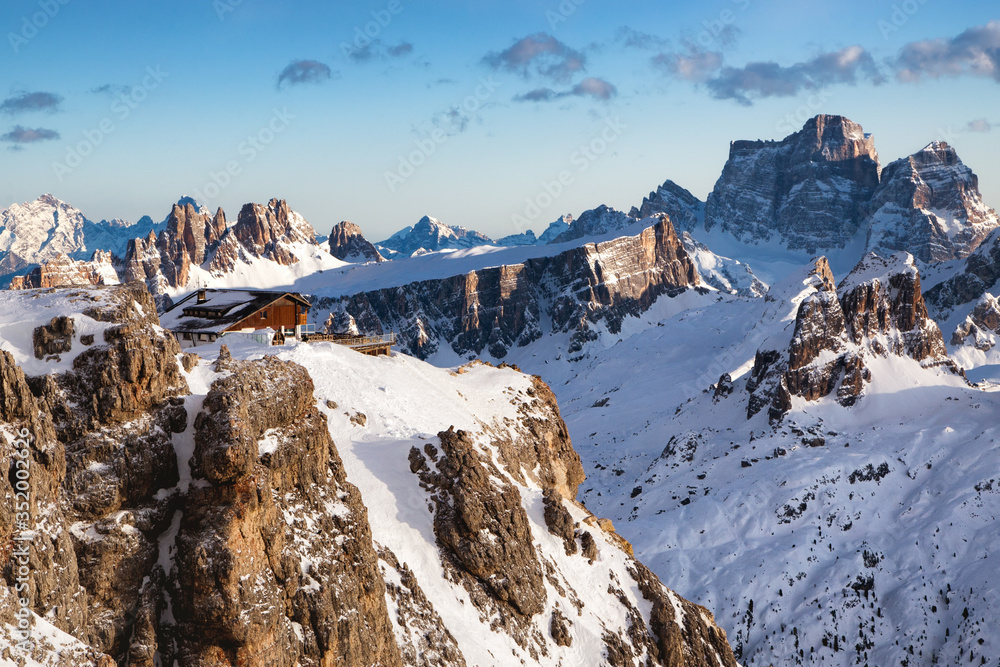 Rifugio Lagazuoi and Cable car station against the background of the Dolomites at sunset. Winter Alps near Cortina d'Ampezzo, Veneto, Italy. Postcard, Falzarego Pass, Dolomiti. Famous observation deck