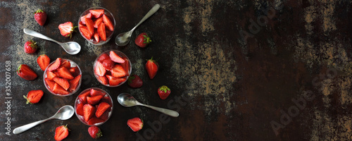 Delicious desserts with strawberries in glasses. Flat lay. Healthy desserts.