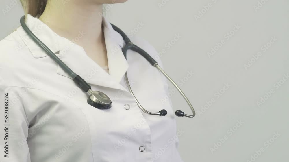 Female doctor putting on stethoscope. Corona. Covid-19 Female doctor putting on stethoscope. Corona. Covid-19