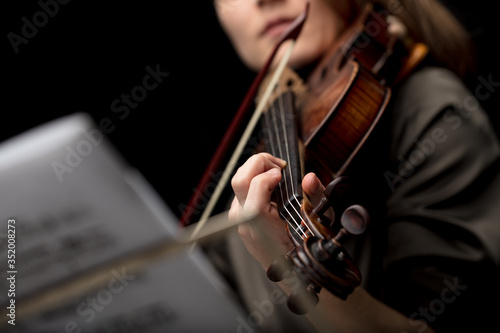Woman violinist playing a classical baroque violin