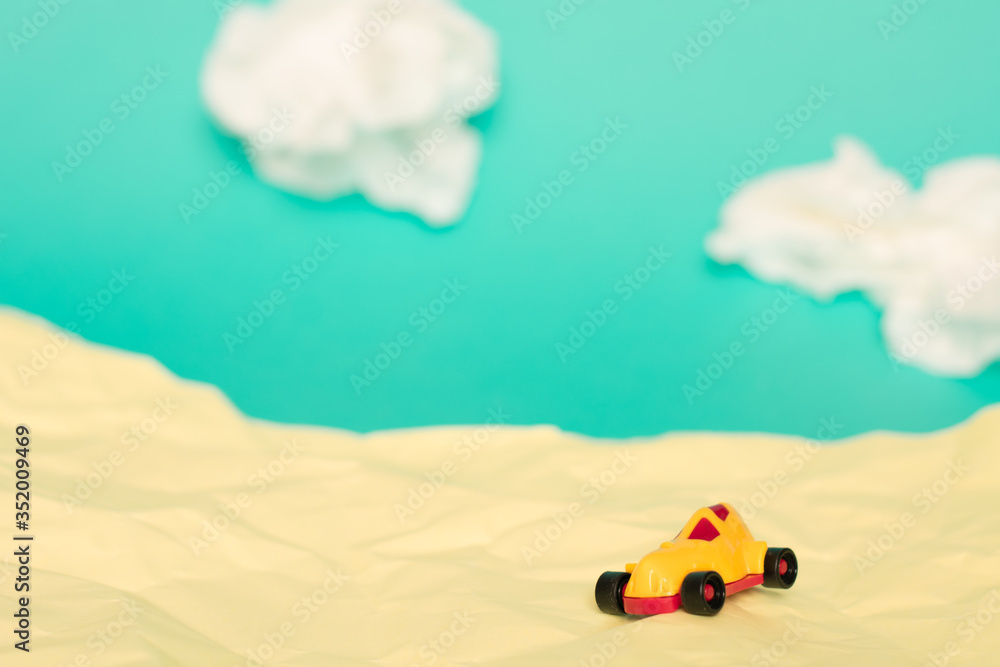Toy car in a handmade beach environment. 