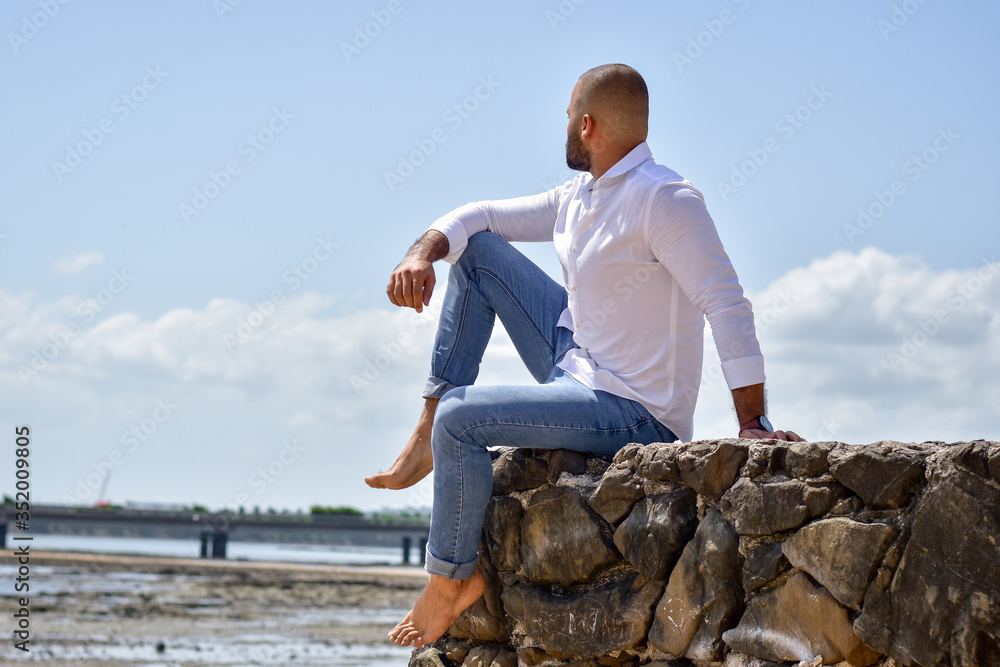 young man sitting on the rocks