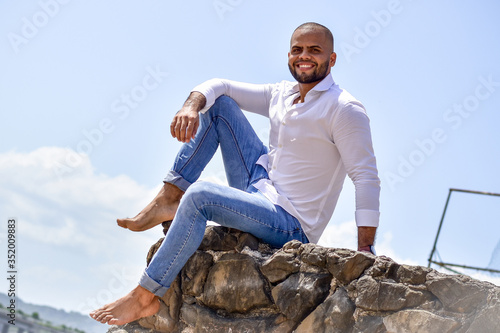 young man sitting on the rocks