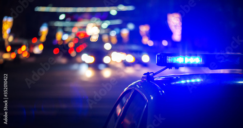 night police car lights in city - close-up with selective focus and bokeh photo