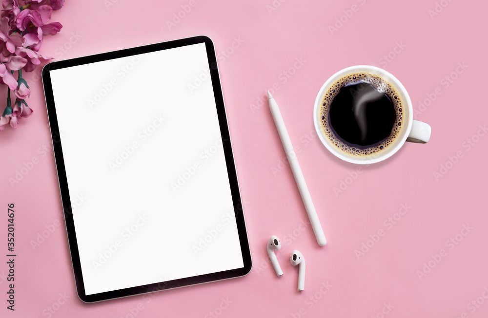 Modern tablet, white wireless headphones with coffee on a pink background. Modern tablet, white wireless headphones with coffee on a pink background.