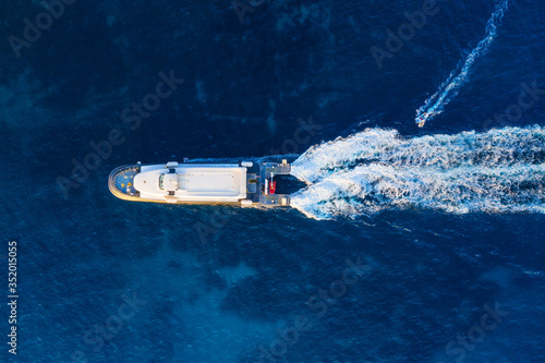 Aerial view of floating ship on blue Adriatic sea at sunny day. Fast ship on the sea surface. Seascape from the drone. Travel - image
