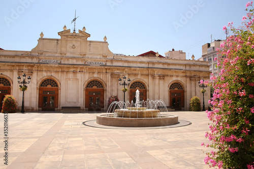 The main town square or Plaza Mayor with a fountain and the Central Market building in the background, Castellon de la plana, Valencia provence, Spain. photo