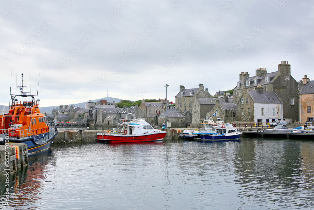 Harbour with fishing boats, lifeboat & buildings in the background, Lerwick, Shetland Islands, Scotland.