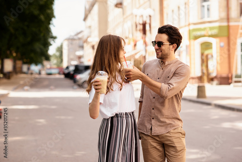 young beautiful couple have a fun and walking on city streets and drinking coffee © jul14ka
