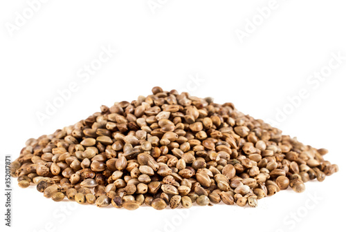 Heap of cannabis seeds isolated on a white background.
