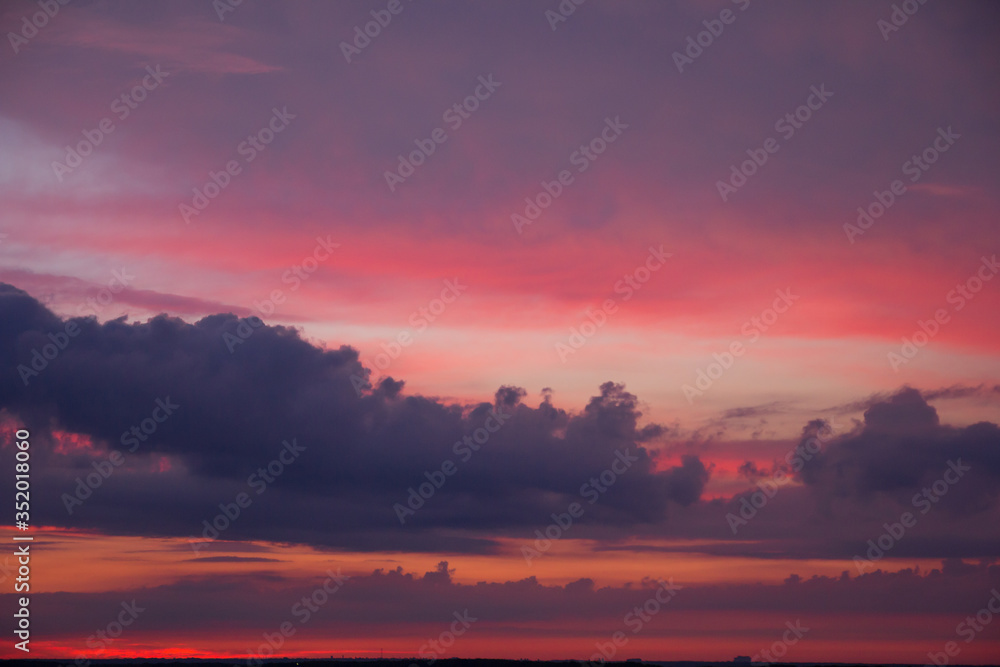 Natural Sunset Sunrise Over Field Or Meadow. Bright Dramatic Sky And Dark Ground. Countryside Landscape Under Scenic Colorful Sky At Sunset Dawn Sunrise. Sun Over Skyline, Horizon. Warm Colours