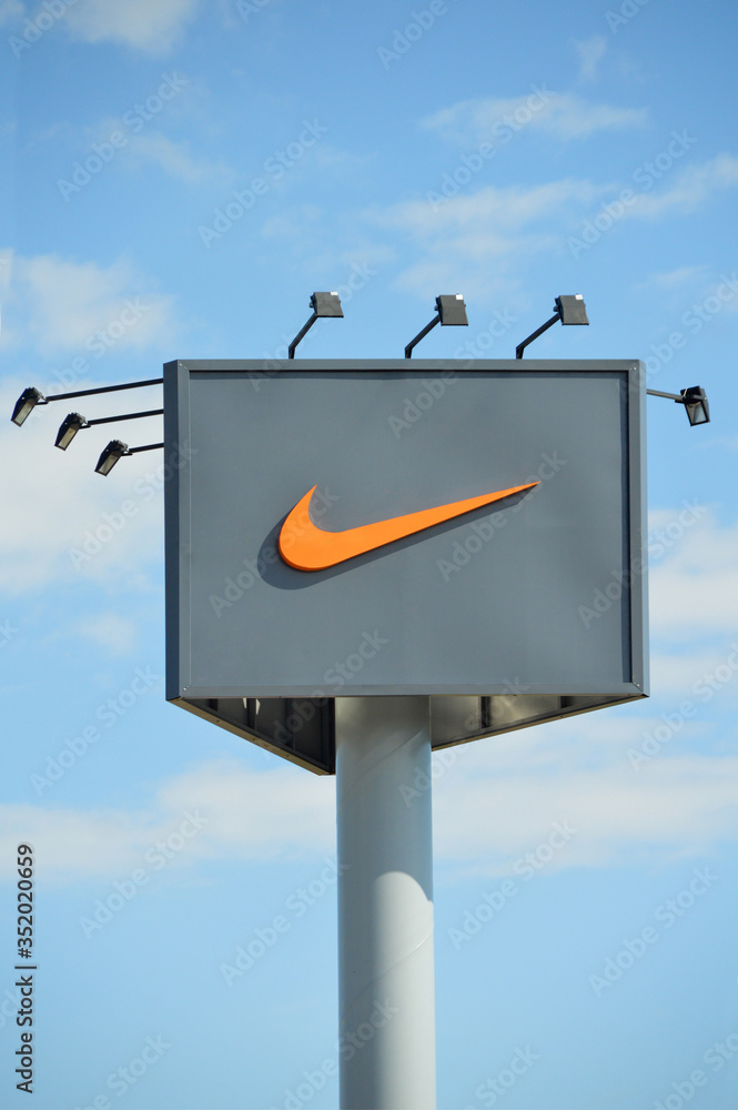 Nike symbol, strong sports brand, outdoor advertising billboard on blue sky  Stock Photo | Adobe Stock